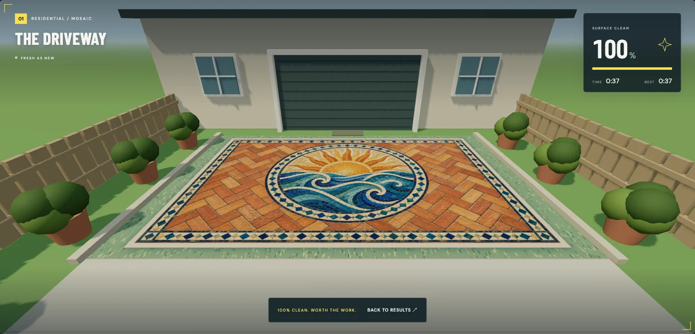 The restored terracotta driveway in PressureWashr, revealing a colorful sun-and-wave mosaic.