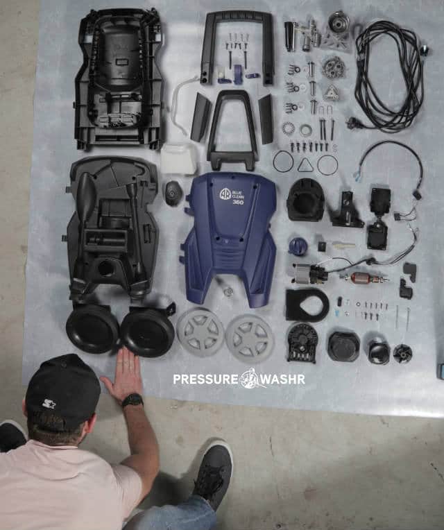 Disassembled AR Pressure Cleaner Showing Person Arrange Parts